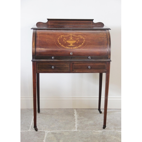 927 - An Edwardian inlaid mahogany cylinder top bureau, the shaped pediment above a fall front centred wit... 