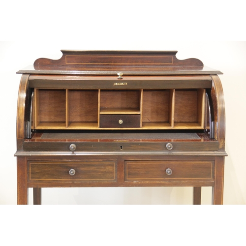 927 - An Edwardian inlaid mahogany cylinder top bureau, the shaped pediment above a fall front centred wit... 