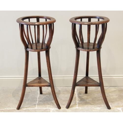 931 - A pair of stained hardwood jardinere stands, 20th century, each with a circular moulded collar upon ... 