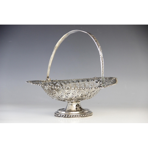 98 - An Edwardian silver swing-handled basket, London 1907 (maker’s marks worn), of oval form on pedestal... 