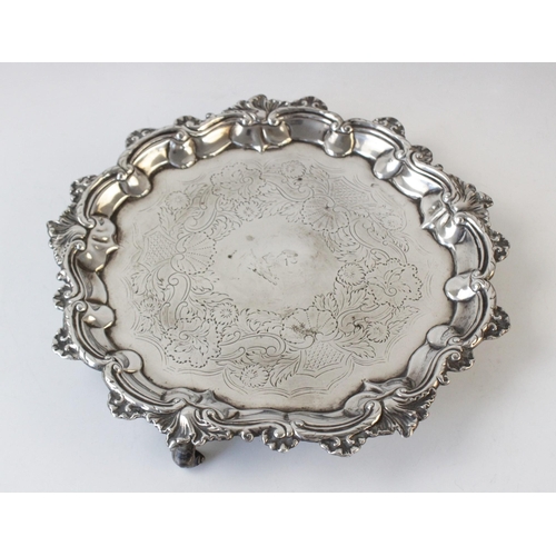 62 - A silver salver circa 1830, possibly by Edward Farrell, of shaped circular form with cast pie crust ... 