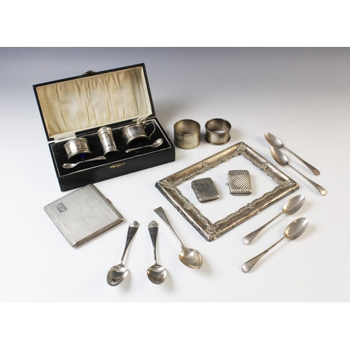 64 - A selection of tableware and accessories, to include a George V cased three-piece silver cruet set b... 