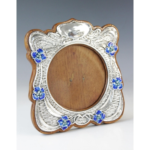 74 - An Art Nouveau silver and enamel photograph frame, Synyer & Beddoes, Birmingham 1904, of shaped squa... 