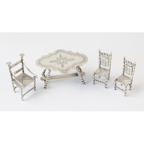 90 - A selection of miniature continental silver coloured doll's house furniture, to include; a bobbin-le... 