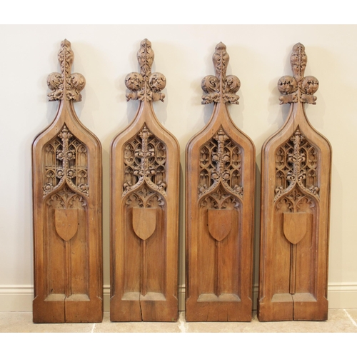 900 - Four English Gothic revival oak pew ends, 19th century, each of ogee gothic arch form with tri-form ... 