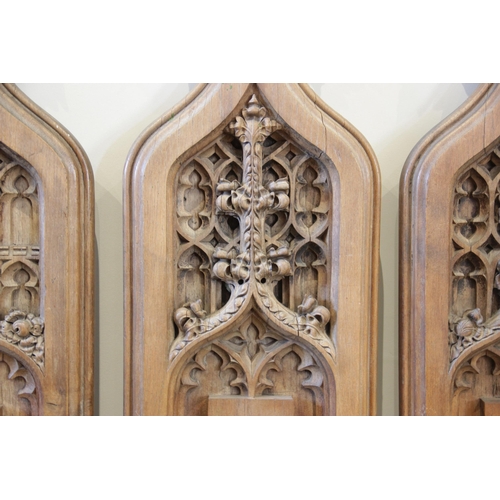 900 - Four English Gothic revival oak pew ends, 19th century, each of ogee gothic arch form with tri-form ... 