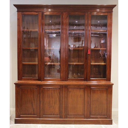 887 - A mid 19th century mahogany library bookcase, the moulded cornice above a plain frieze and two pairs... 