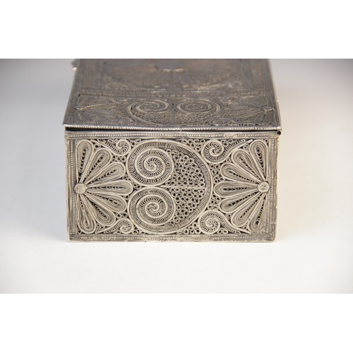 53 - An Indian white metal wirework casket, of rectangular form with hinged cover, decorated with scrolli... 
