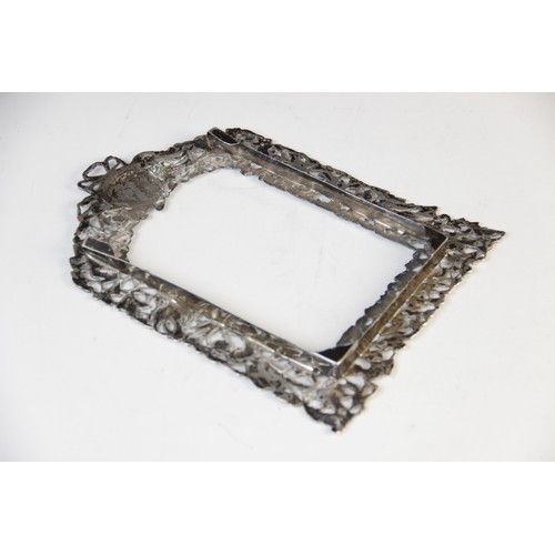 75 - A pair of Victorian silver photograph frames by William Comyns, London 1894, of arched rectangular f... 