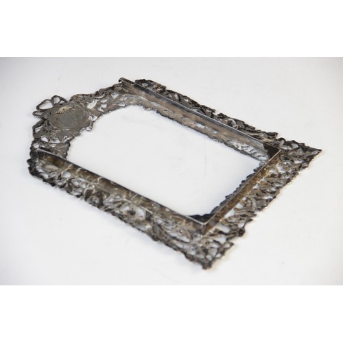 75 - A pair of Victorian silver photograph frames by William Comyns, London 1894, of arched rectangular f... 