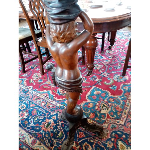 896 - An Italian stained and carved hardwood cherub figural pedestal table, late 19th/early 20th century, ... 