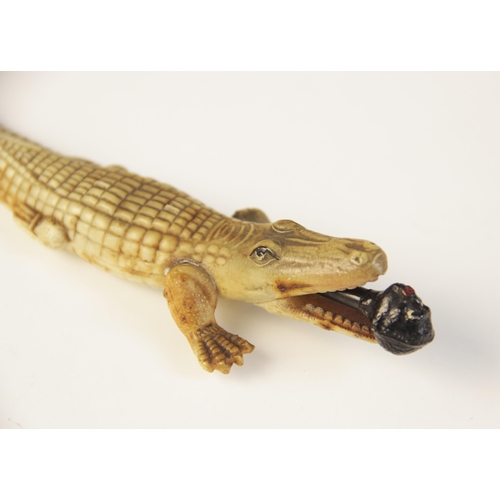 108 - An early 20th century celluloid novelty combination pencil and letter knife, modelled as a crocodile... 