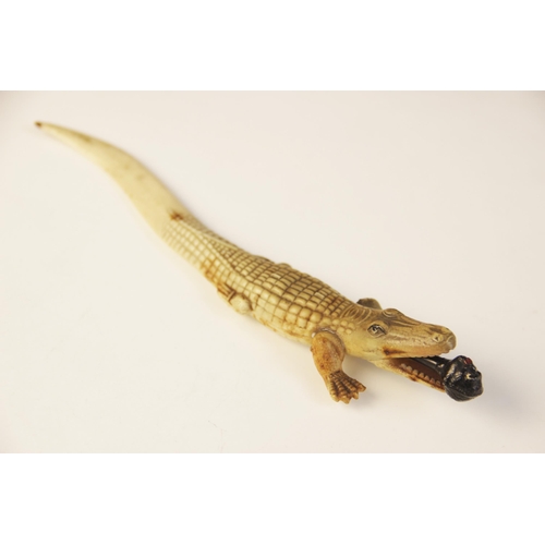 108 - An early 20th century celluloid novelty combination pencil and letter knife, modelled as a crocodile... 