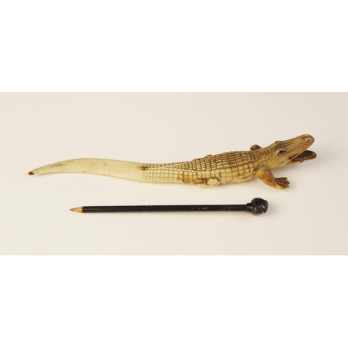 108 - An early 20th century celluloid novelty combination pencil and letter knife, modelled as a crocodile... 