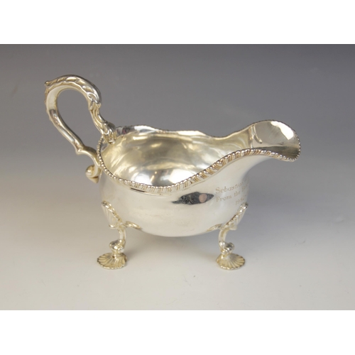 14 - A George III silver sauce boat, marks for London 1761 (maker's marks worn), of typical form with wav... 