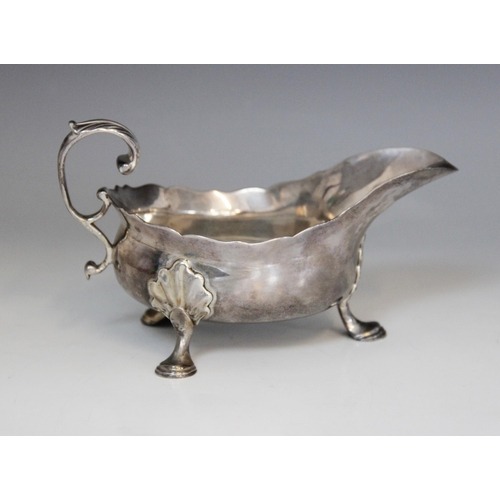 18 - A George II silver sauce boat, Isaac Cookson, Newcastle 1752, of typical form with scalloped border,... 