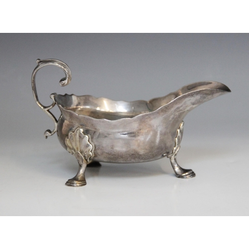 18 - A George II silver sauce boat, Isaac Cookson, Newcastle 1752, of typical form with scalloped border,... 