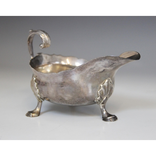18 - A George II silver sauce boat, Isaac Cookson, Newcastle 1752, of typical form with scalloped border,... 