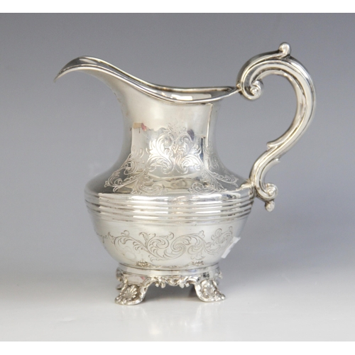 50 - A Victorian silver milk jug, Richard Pearce & George Burrows, London 1843, of baluster form on four ... 