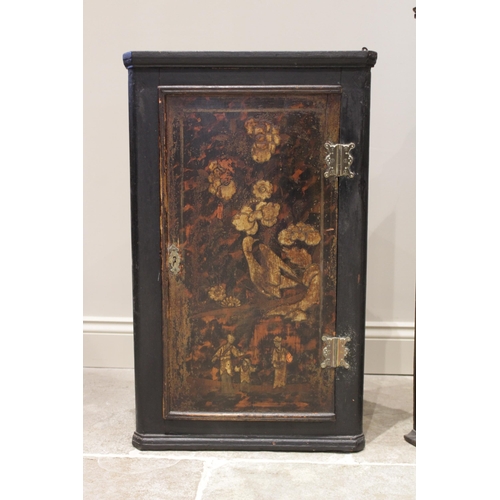 581 - A 19th century Japanned bowfront hanging corner cupboard, the twin doors applied with painted detail... 