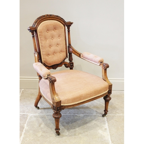 599 - A French walnut salon chair, circa 1880, the arched button back below leaf and berry carved detail a... 