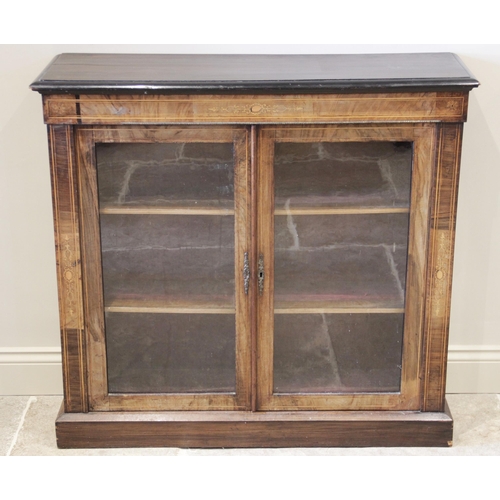 600 - A Victorian rosewood pier cabinet, the rectangular moulded top above a pair of glazed doors opening ... 