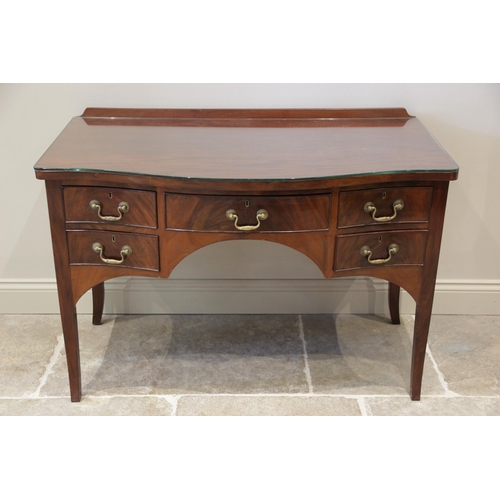 602 - A 19th century mahogany serpentine side table, with a galleried back over the serpentine top and an ... 