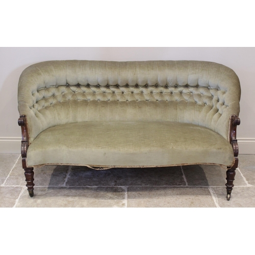 603 - A Victorian rosewood sofa, upholstered in green velour, the button back extending to carved scrolled... 