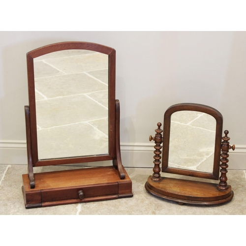 606 - A Victorian mahogany dressing table mirror, the arched mirrored plate raised upon curved supports an... 