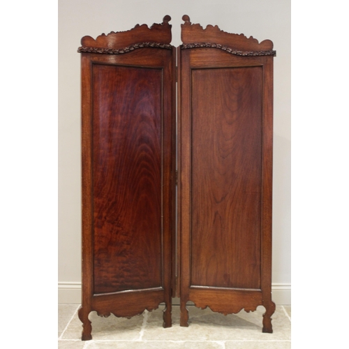 612 - A late 19th/early 20th century carved walnut Rococo style twin panel screen, each screen with a scro... 