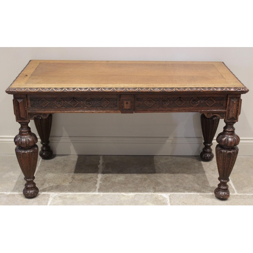 613 - A Victorian carved oak gothic influence side table, the rectangular top with a lunette carved border... 