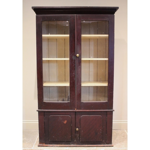 619 - A Victorian stained pine kitchen cabinet, the moulded cornice above a pair of glazed doors opening t... 