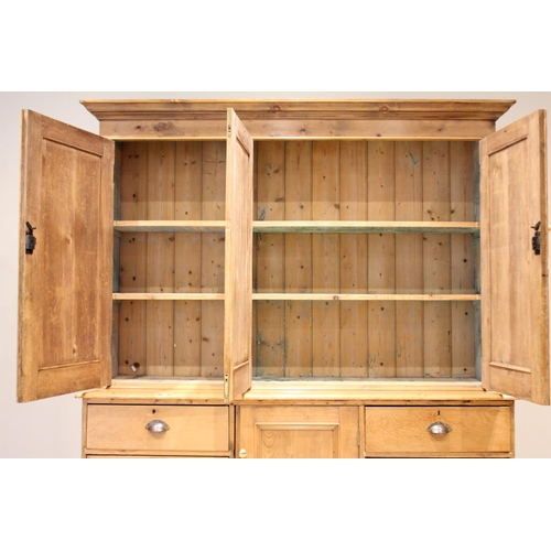 620 - A Victorian pine housekeepers cupboard, the moulded cornice above three invert moulded cupboard door... 