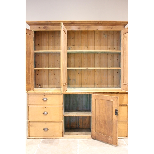 620 - A Victorian pine housekeepers cupboard, the moulded cornice above three invert moulded cupboard door... 