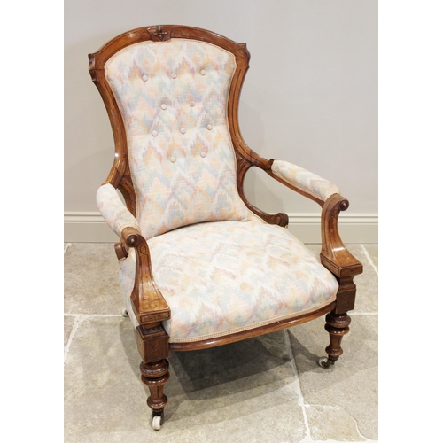 628 - A Victorian walnut open armchair, the shaped button back extending to padded out swept arms with rou... 