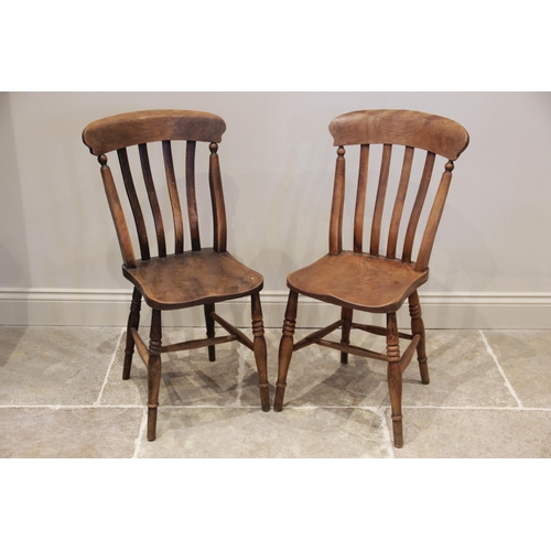 629 - A matched set of six elm and beech wood Victorian kitchen chairs, each chair with a lath back over a... 