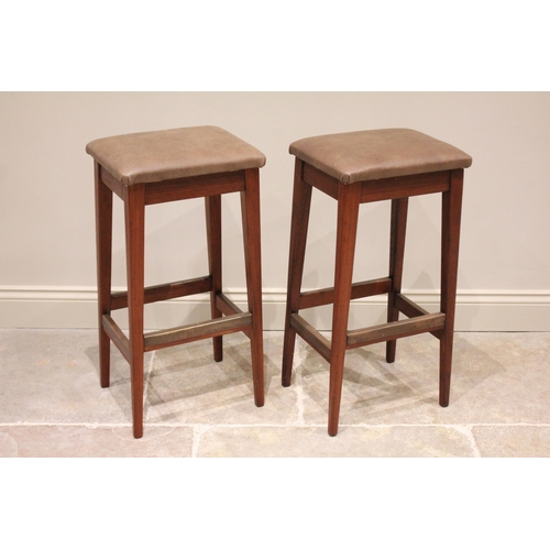 648 - A pair of mid century Gordon Russell teak bar stools, the later re covered upholstered seats raised ... 