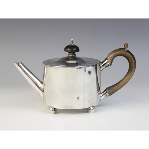 68 - A George III silver bachelor’s teapot by William Troby, London 1812, of cylindrical form on four bun... 