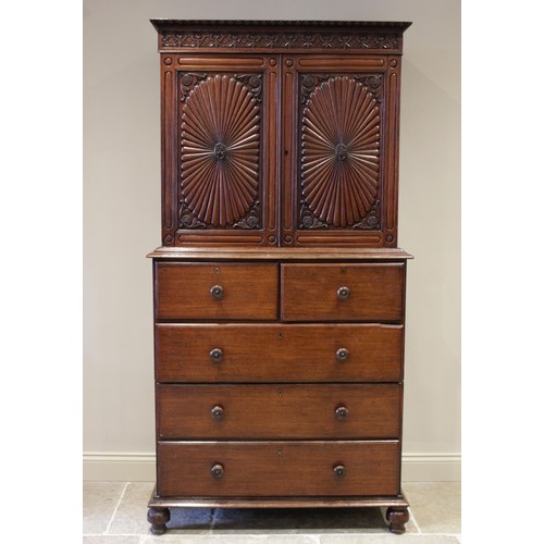 610 - A mid 19th century Anglo Indian teak linen press, the upper frieze carved with leafy swags and scrol... 