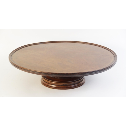 615 - A 19th century mahogany Lazy Susan, of typical form with turned pedestal base and revolving circular... 