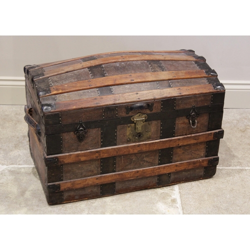 601 - A late 19th century domed steamer trunk by F A Patterson, the slatted and leather covered trunk appl... 