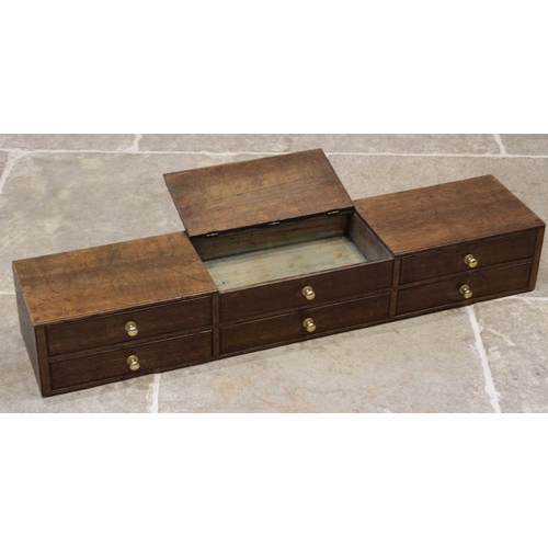 608 - An early 20th century oak desk top chest, the central hinged compartment with faux drawer moulding, ... 