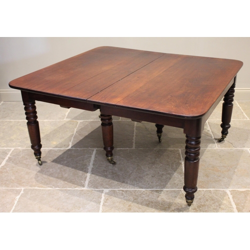 621 - A mid 19th century mahogany extending dining table, the rectangular top with rounded corners raised ... 