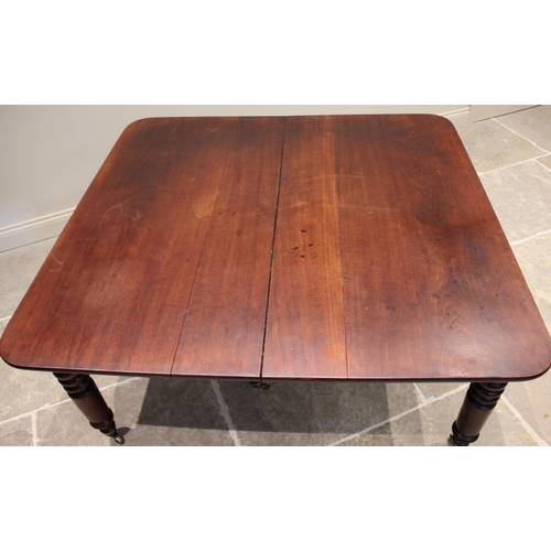 621 - A mid 19th century mahogany extending dining table, the rectangular top with rounded corners raised ... 