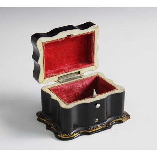 90 - A papier mache miniature casket, 19th century, the serpentine form casket decorated with holly and b... 