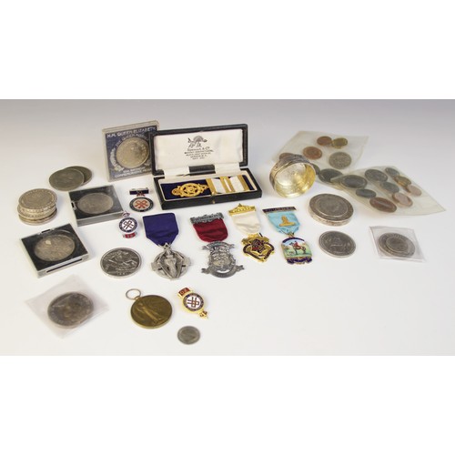 76 - A selection of coins and medallions, to include a silver box inset with European coins, assorted sil... 