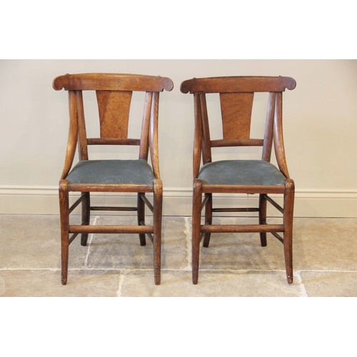 614A - A pair of maple side chairs in the manner of  Biedermeier, circa 1830, each chair with a concave top... 