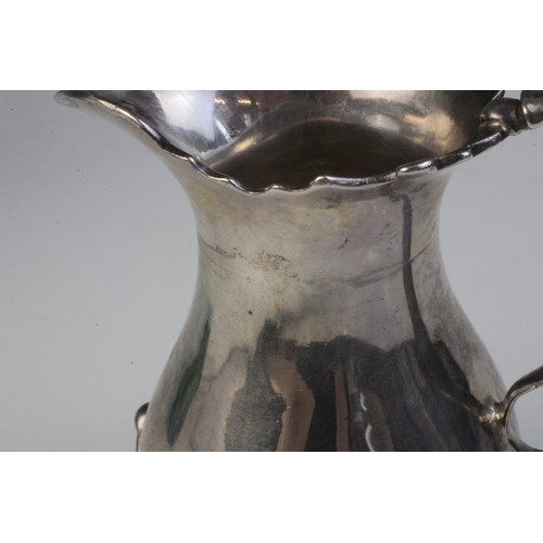 32 - A George II silver milk jug, possibly John Kirkup, Newcastle 1748, of baluster form with shaped rim,... 