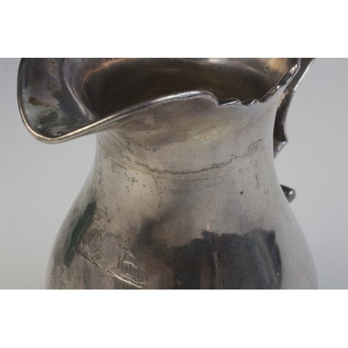 32 - A George II silver milk jug, possibly John Kirkup, Newcastle 1748, of baluster form with shaped rim,... 