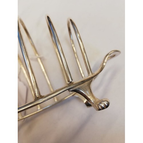 16 - A Victorian silver six-division toast rack, Henry Wilkinson & Co, London 1893, the shaped base with ... 